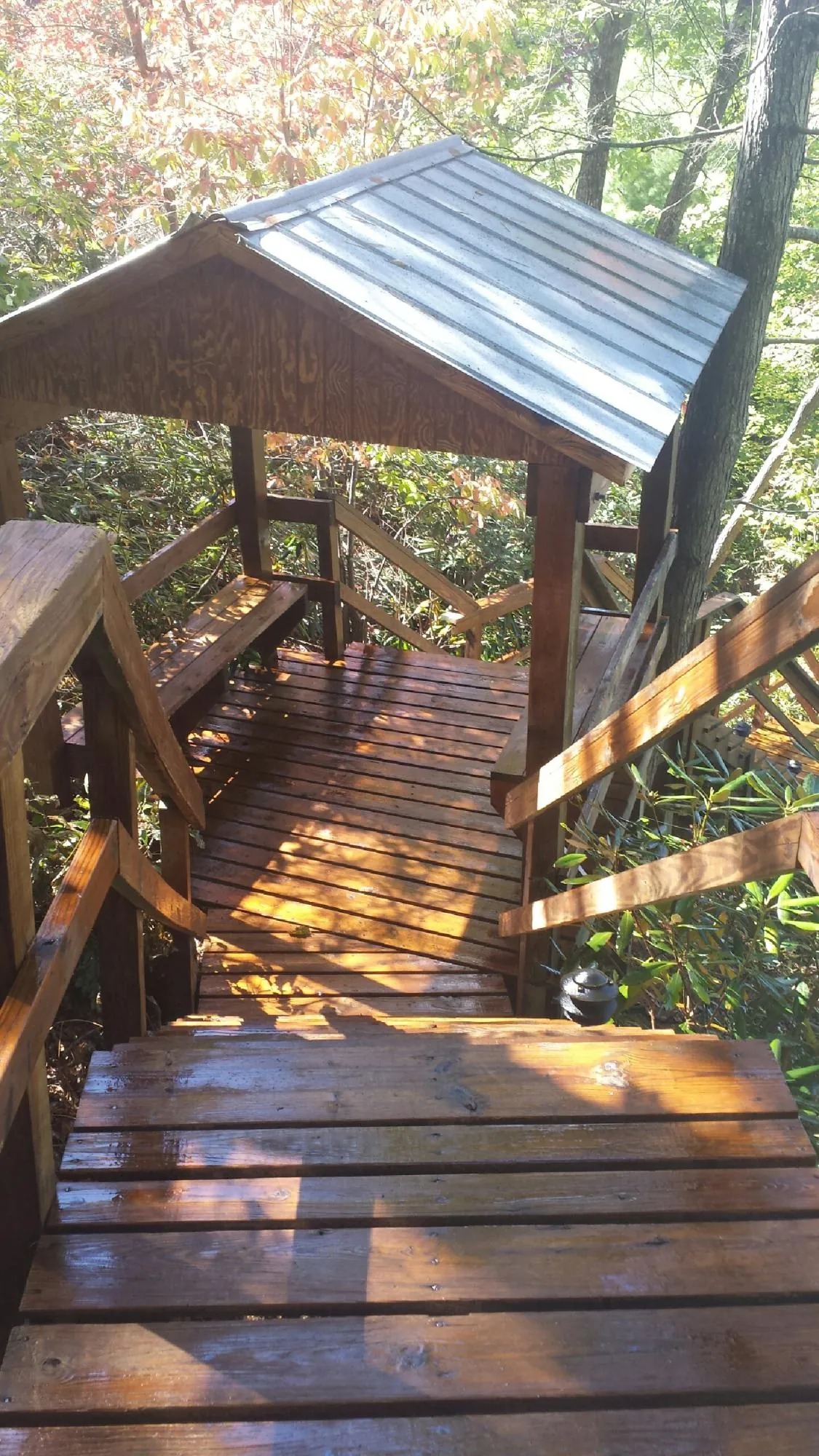 Freshly stained wood walkway and covered shelter with a metal roof in Miramar Beach